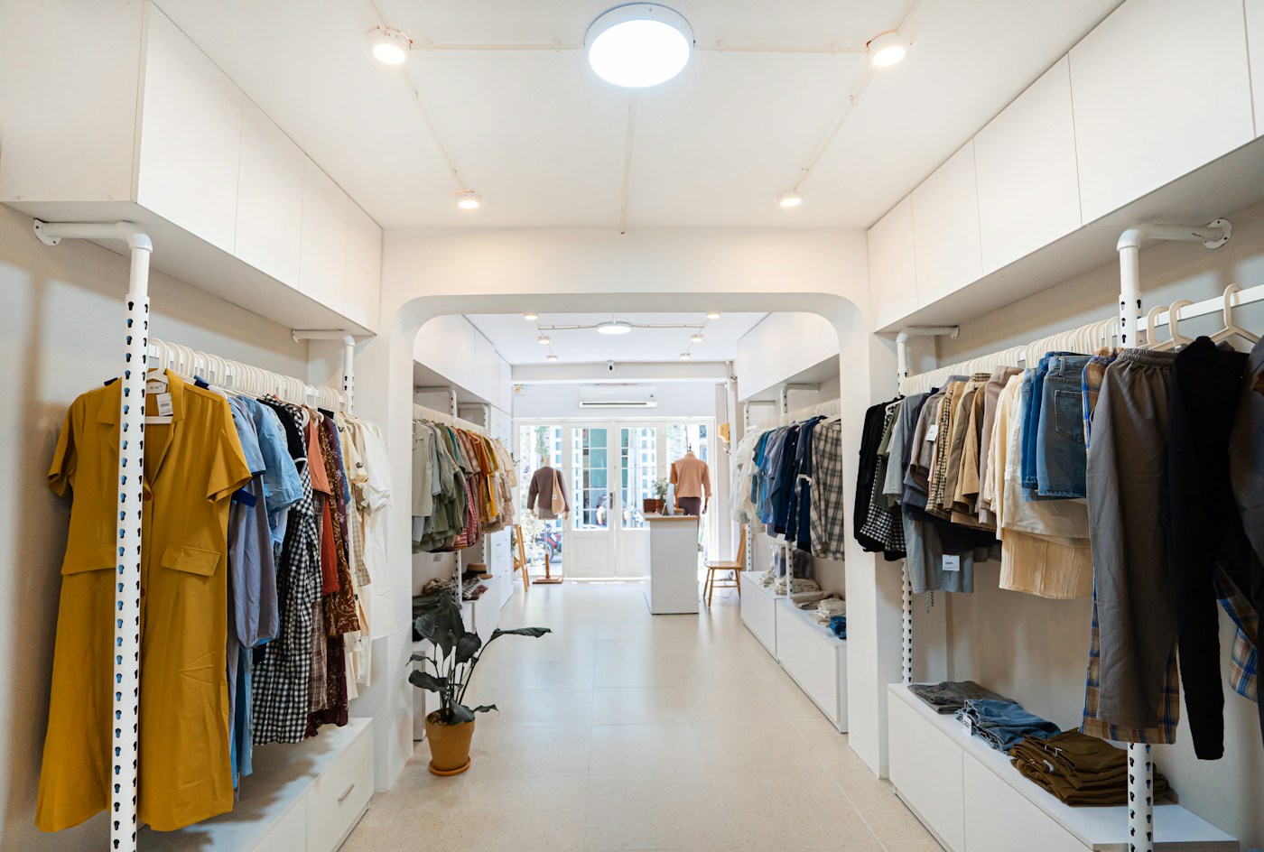 Bright clothing boutique with garments displayed on racks